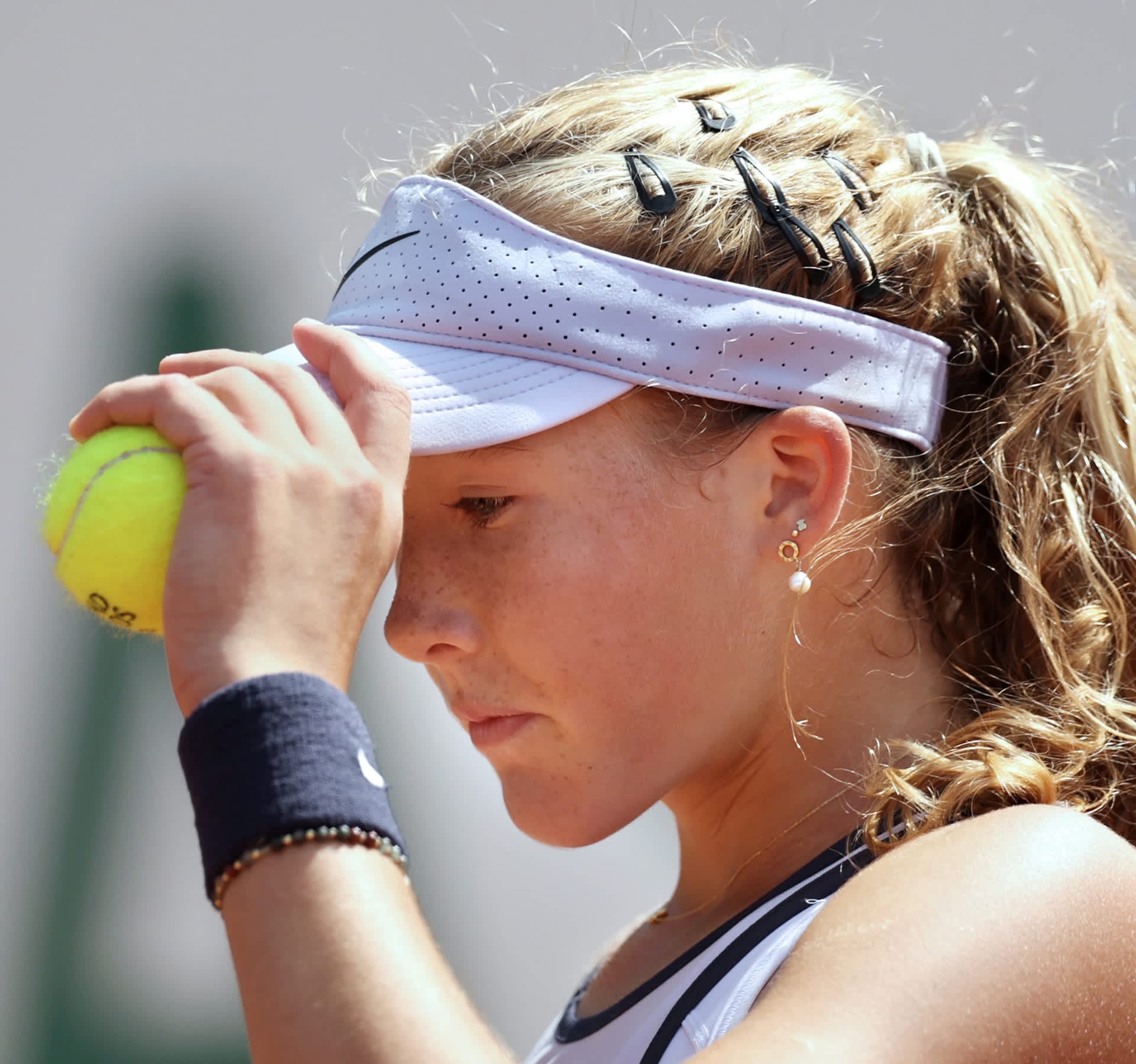 Mirra Andreeva with tennis ball in hand
